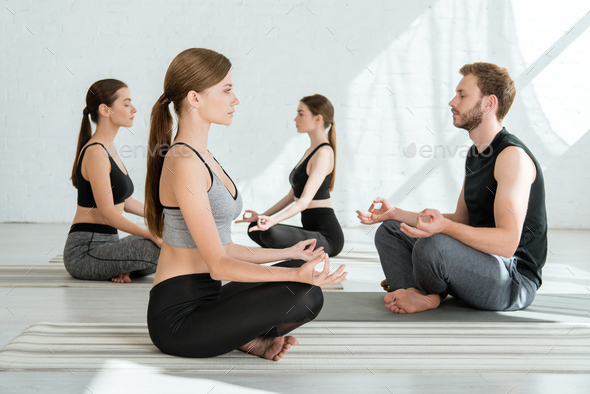 Happy Middle-aged Woman Practicing Half Lotus Pose of Yoga One Hand Raised  with Her Family Stock Image - Image of fitness, classes: 278962877