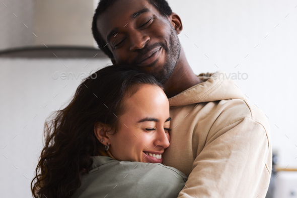 Loving Young Couple Hugging At Home Standing In Kitchen Together - Stock Photo - Images