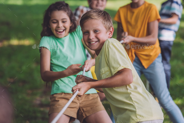 selective focus of happy children competing in tug of war Stock Photo ...