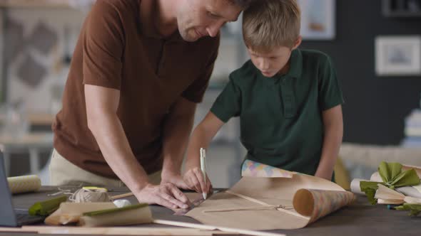 Father And Son Making DIY Kite alt