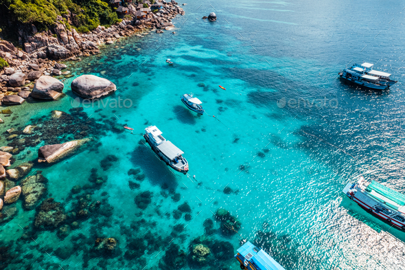 Boats and crystal clear waters at the bay dive site in Koh Tao,diving tour boat