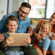 Device technology family online education concept. Happy family with digital devices at home - PhotoDune Item for Sale
