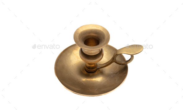 Candle in brass chamberstick holder isolated Stock Photo