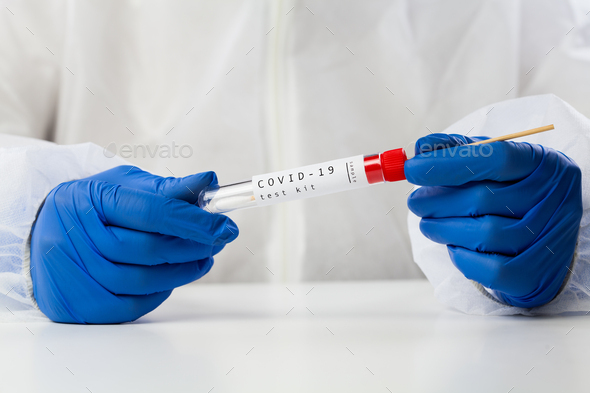 Lab technician holding swab collection kit