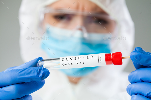 Medical healthcare technologist holding COVID-19 swab collection kit