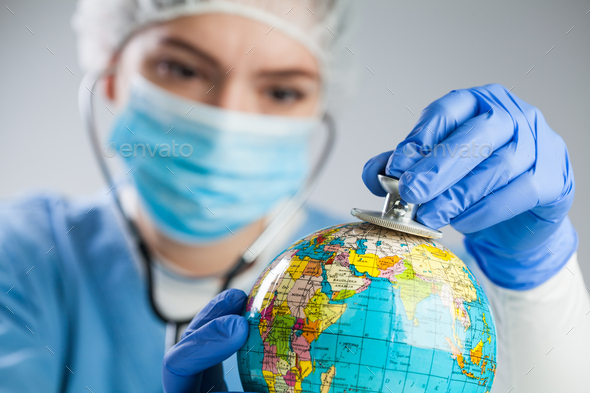 Doctor using a stethoscope to listen to the planet Earth globe and set diagnosis - Stock Photo - Images