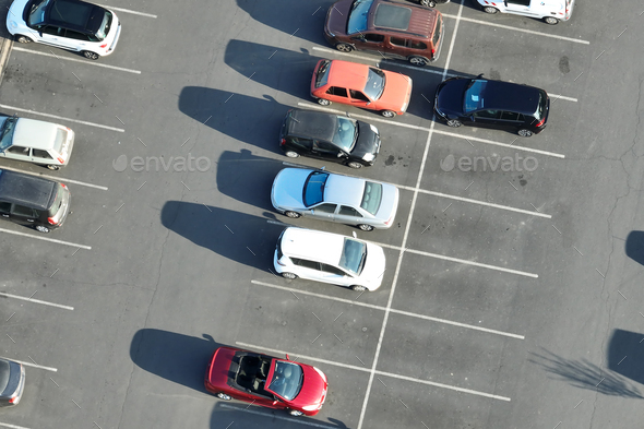 Aerial view of many colorful cars parked on parking lot with lines and markings for parking places - Stock Photo - Images