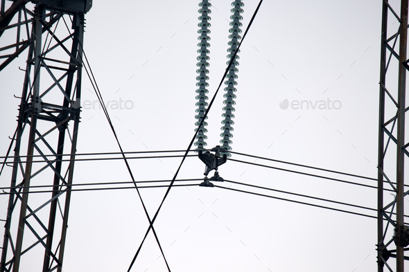High voltage tower with electric power lines divided by safe guard bushing transfening safely