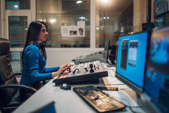 Middle aged woman using equipment in control room on a tv station