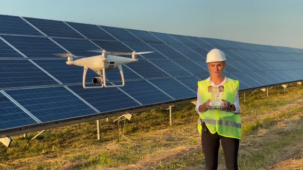 Technician and Investor Using Infrared Drone Technology to Inspect Solar Panels and Wind Turbines in