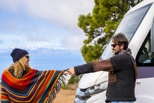 Couple of happy tourist enjoy camper parking destination in the nature. Free travel lifestyle