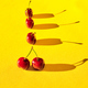 Top view of five red cherries with shadow isolated on a yellow background - PhotoDune Item for Sale