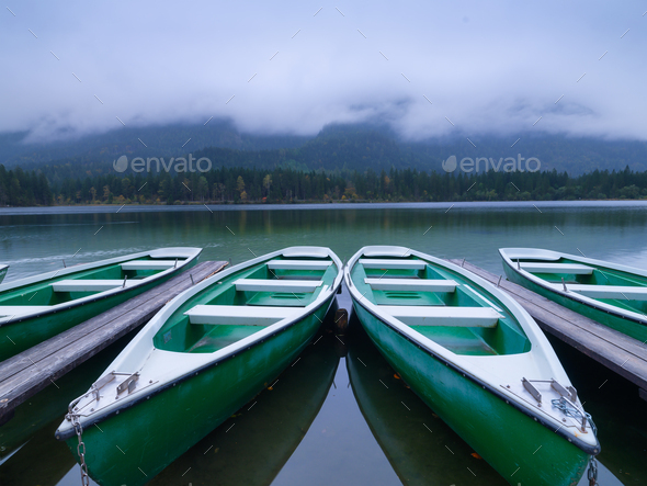 Boats on the Hintersea lake, Germany. Landscape during fog. Lake and trees.