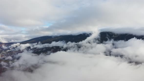 Flight Through Blue Sky with Clouds Over Mountain alt