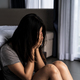 Lonely young woman feeling depressed and stressed sitting in the dark bedroom - PhotoDune Item for Sale