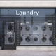 Laundry building exterior with washing machines inside it. - PhotoDune Item for Sale