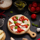 Italian pizza with ingredients on table. Pizza cooking at tabletop background - PhotoDune Item for Sale