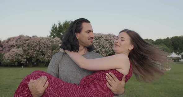 Young Enamored Friends Hugging and Circling in the Park in Slow Motion alt