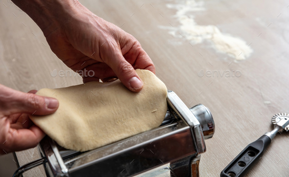 Fresh pasta maker machine. Dough homemade preparation. Hand make