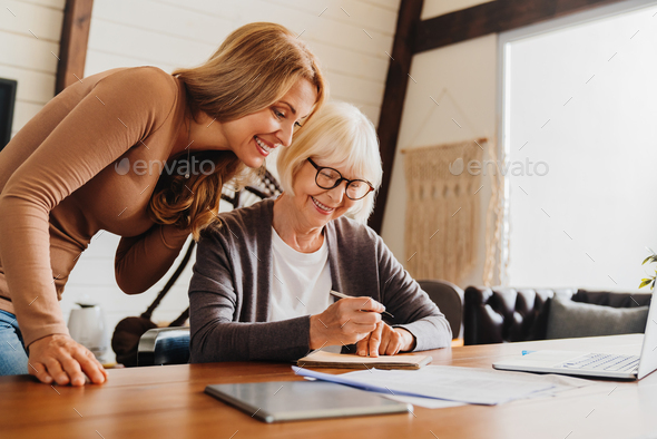 Investment advisor consulting with retired woman at home. - Stock Photo - Images