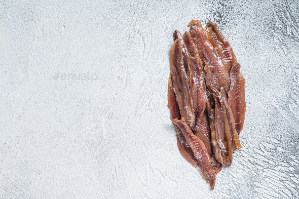 Canned Anchovies fish fillet in Olive Oil. White background. Top view. Copy space