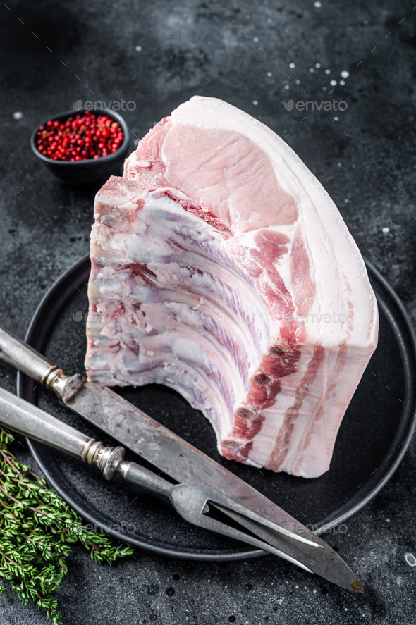 Fresh Raw whole rack of pork loin chops with ribs on a plate with meat