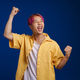 Asian boy with pink hair screaming while making winner gesture - PhotoDune Item for Sale