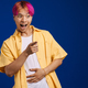 Asian boy with pink hair laughing while pointing finger aside - PhotoDune Item for Sale