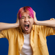 Asian boy with pink hair screaming while holding his head - PhotoDune Item for Sale