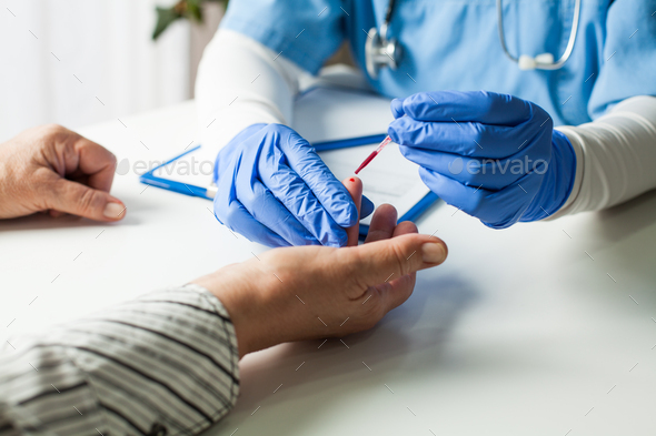 NHS UK doctor taking patient blood sample - Stock Photo - Images