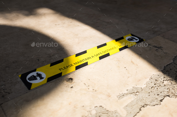 MAINTAIN A SAFE DISTANCE sign on the ground - Stock Photo - Images