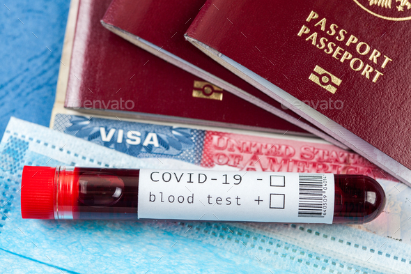 Blood sample test tube and several passports with USA American visa - Stock Photo - Images