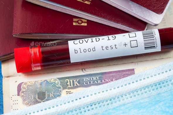 Blood sample test tube & several passports with UK British visa