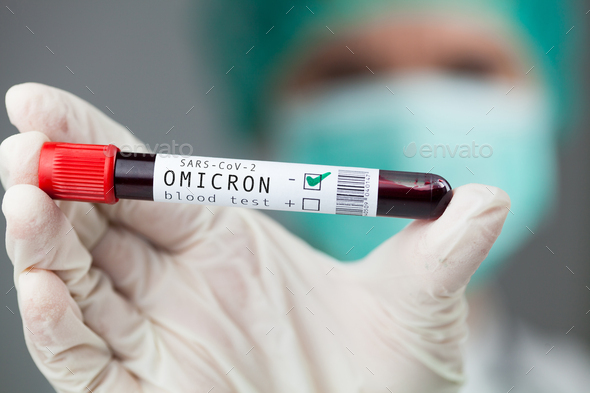 Doctor holding test tube specimen holder containing Omicron variant Coronavirus patient blood sample - Stock Photo - Images