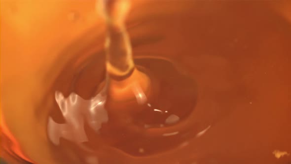 Super Slow Motion Drops Fall Into Freshly Squeezed Apple Juice with Sprays alt