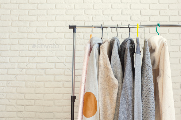 Row of black and white t-shirts hanging on rack Stock Photo by FabrikaPhoto