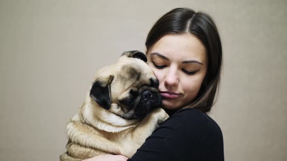 Close Up of the Lovely Woman Hugging a Cute Fat Pug Dog alt