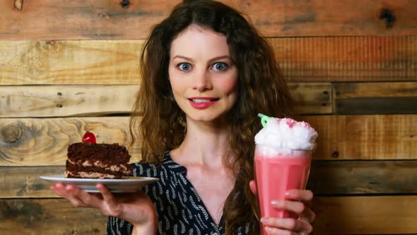 Portrait of female customer holding plate with pastry and icecream float alt