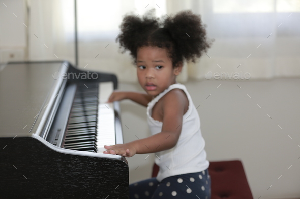 American African young pianist, Afro girl kid playing piano Stock Photo ...