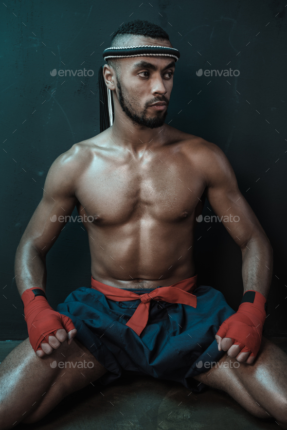 Muay Thai athlete training at Thai boxing indoors, ultimate fight concept