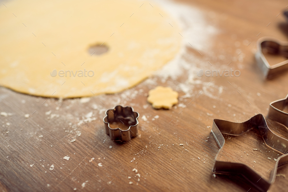 close up view of raw dough and cookie cutters on table - Stock Photo - Images