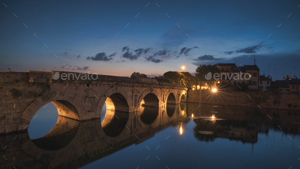 Augustus and Tiberius Bridge in Rimini at night - Stock Photo - Images