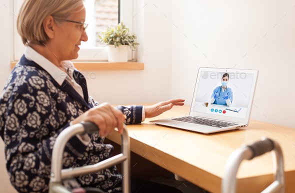 Retired senior elderly woman with mobility problem talking to UK NHS GP female doctor via video call - Stock Photo - Images