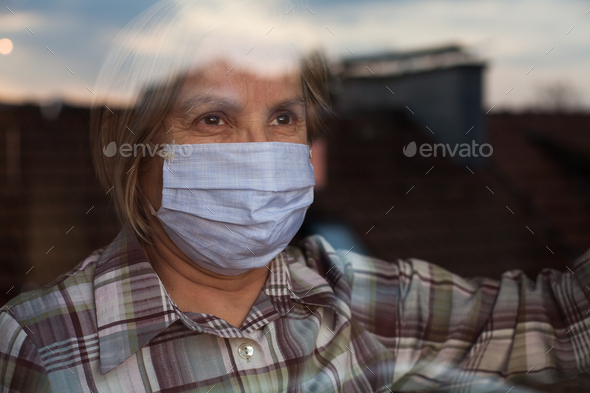 Elderly caucasian woman wearing handmade protective face mask - Stock Photo - Images