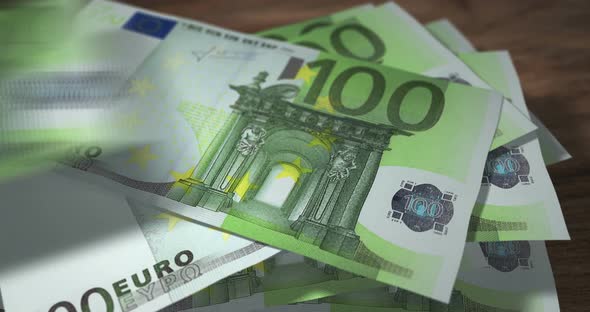 Euro 100 money banknotes falling on the table