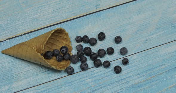 Berry Ice Cream Berries of Blueberries in a Waffle on a Blue Wooden Background alt