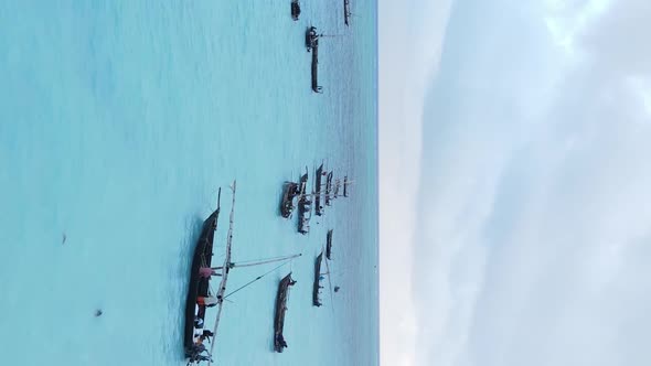 Vertical Video Boats in the Ocean Near the Coast of Zanzibar Tanzania Aerial View alt