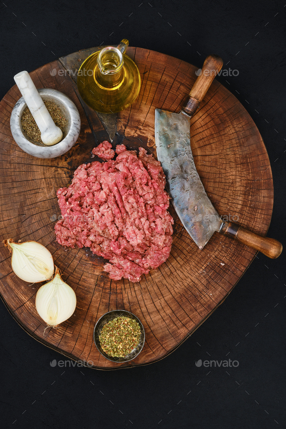 Making fresh mince meat with chopping knife, overhead view. Stock Photo