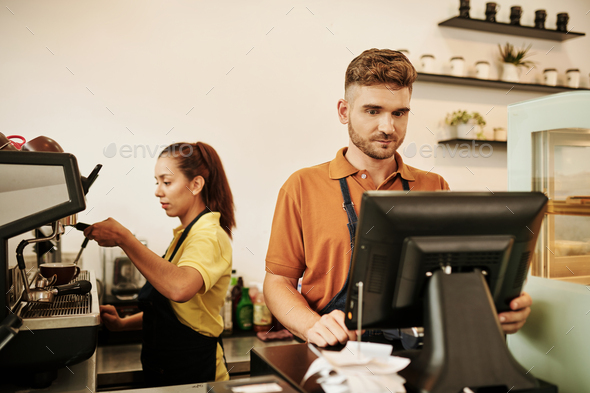 Barista Working at Cashier Desk