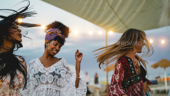 Multiracial friends having fun dancing together outdoor at beach party ...